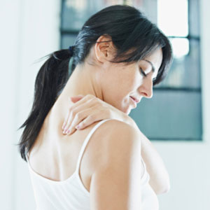 Woman holding neck in pain